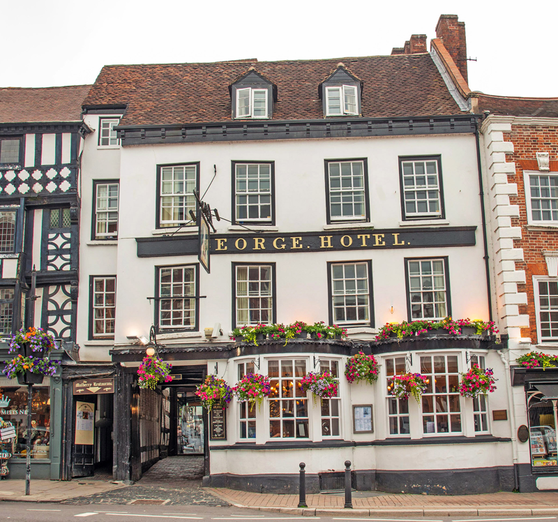 The George Hotel on Load Street, Bewdley The George Hotel on Load Street in Bewdley, with hanging flower baskets and the George Hotel sign across the front.